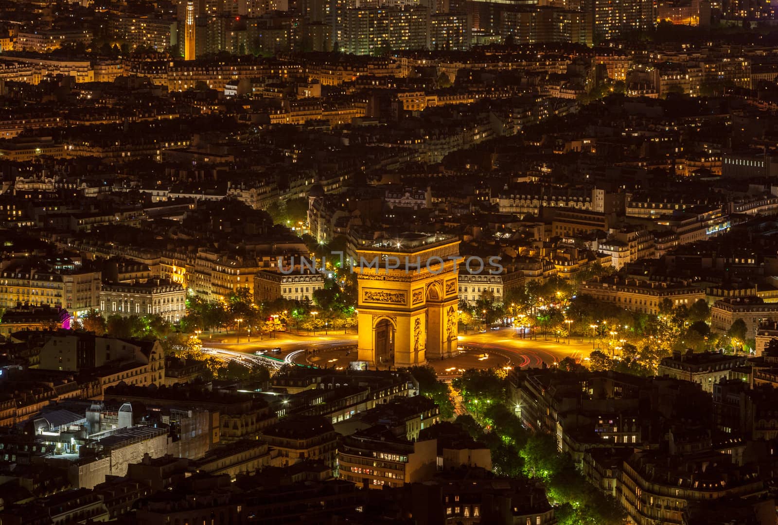 Aerial view of the Triumphal Arch area in Paris during the night.This very famous monument of Europe is located at an intersection of 12 roads in the big city.