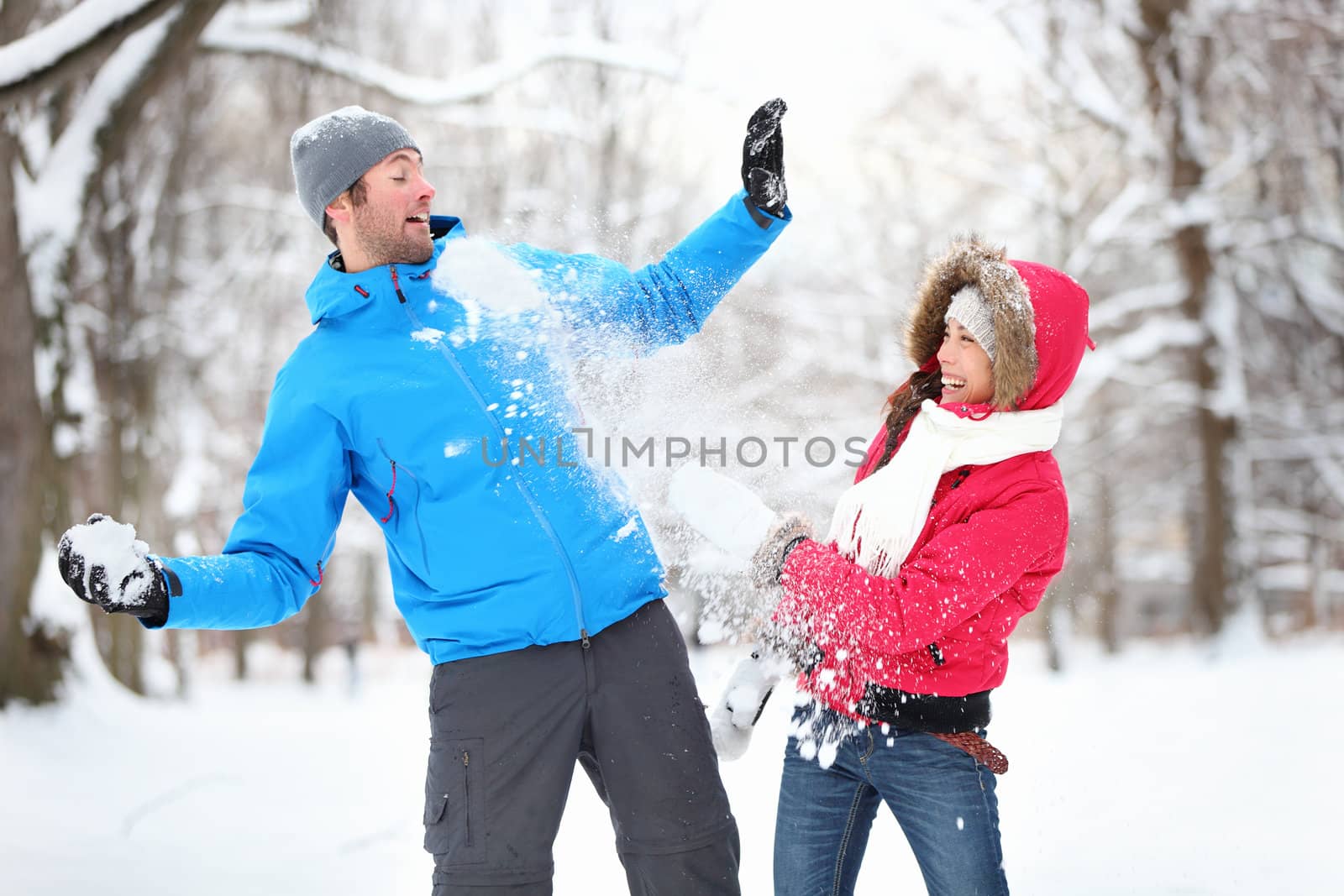 Young couple in snowball fight by Maridav