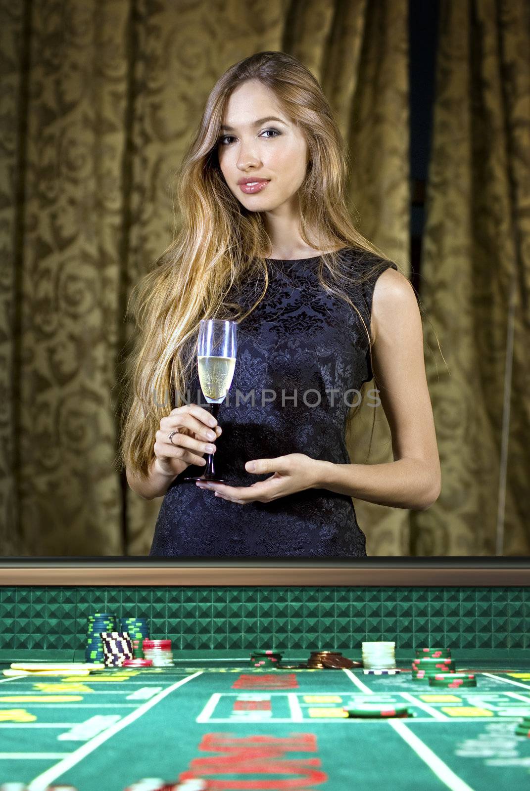 beautiful woman in a casino gambling on the roulette