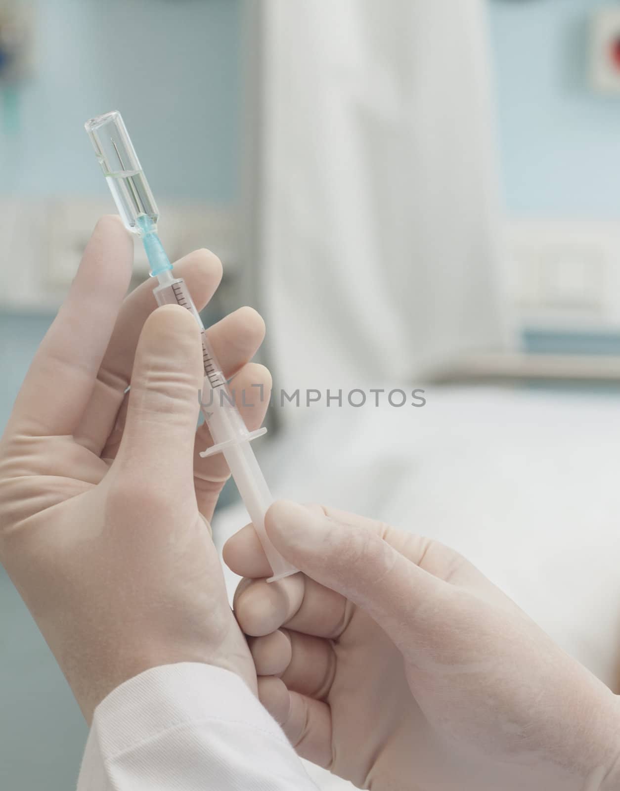 Close up of doctor preparing a syringe in hospital ward