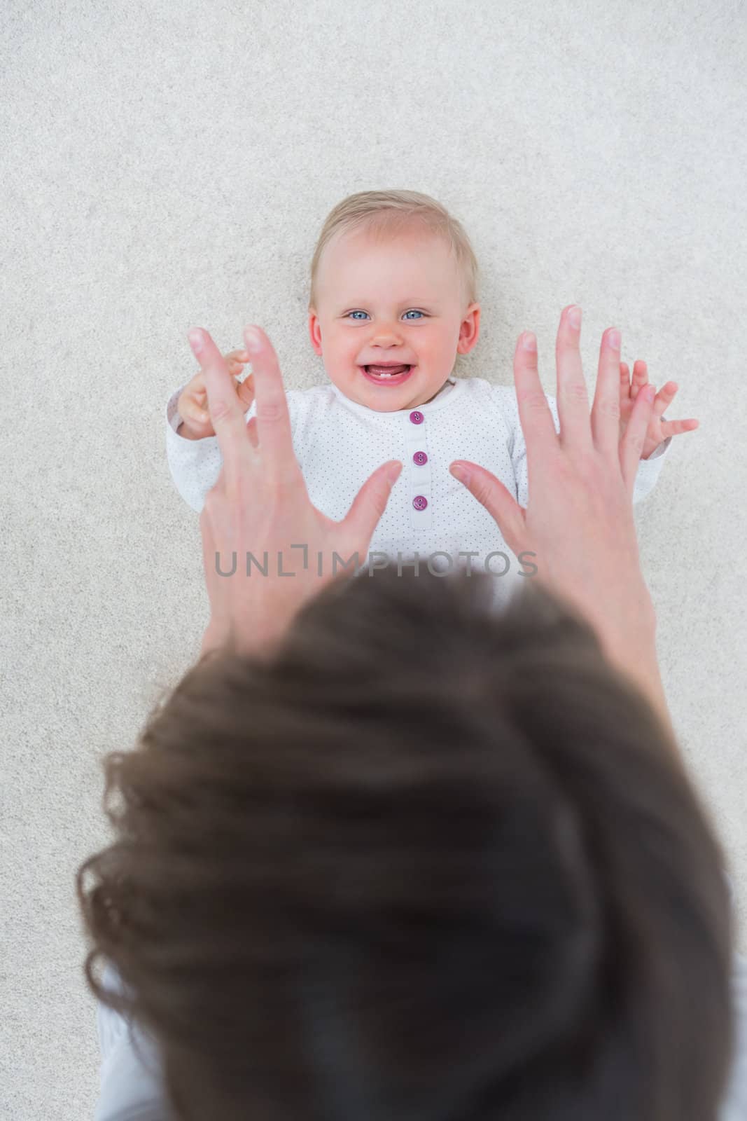 High view of a baby lying on back while playing by Wavebreakmedia
