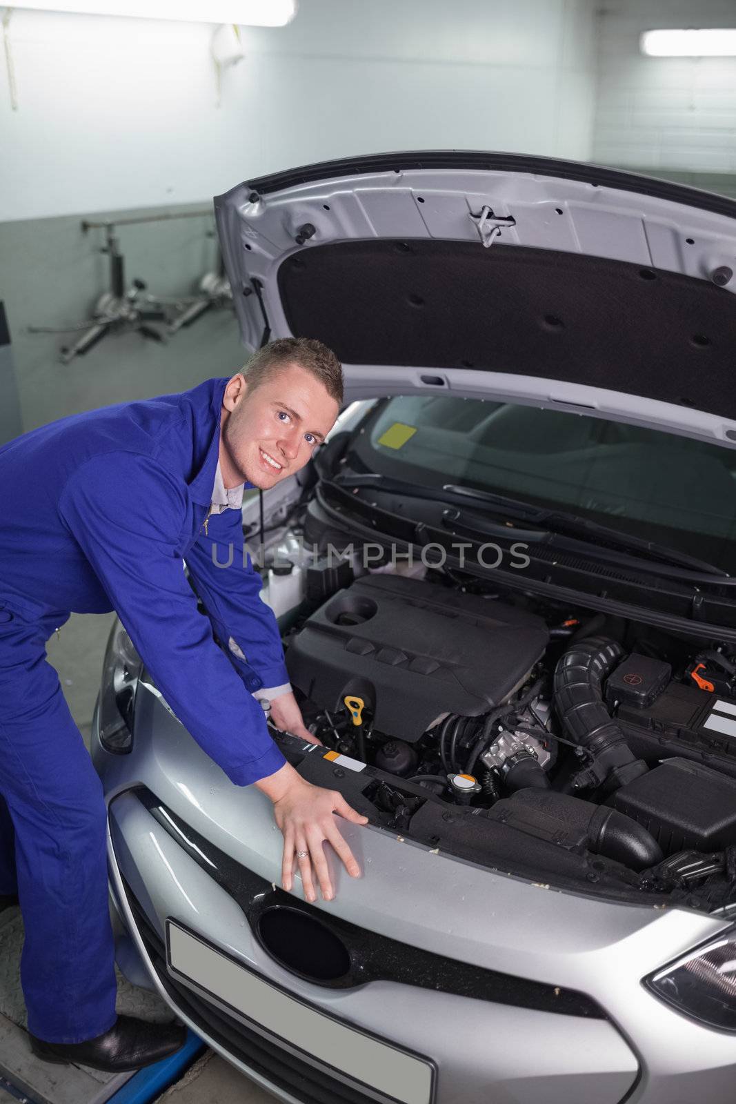 Mechanic repairing a car engine in a garage