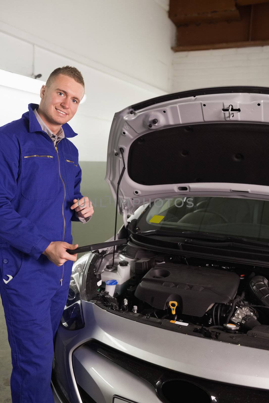 Mechanic holding a tablet computer in a garage