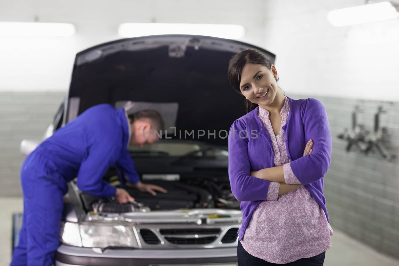 Front view of a smiling client looking at camera in a garage