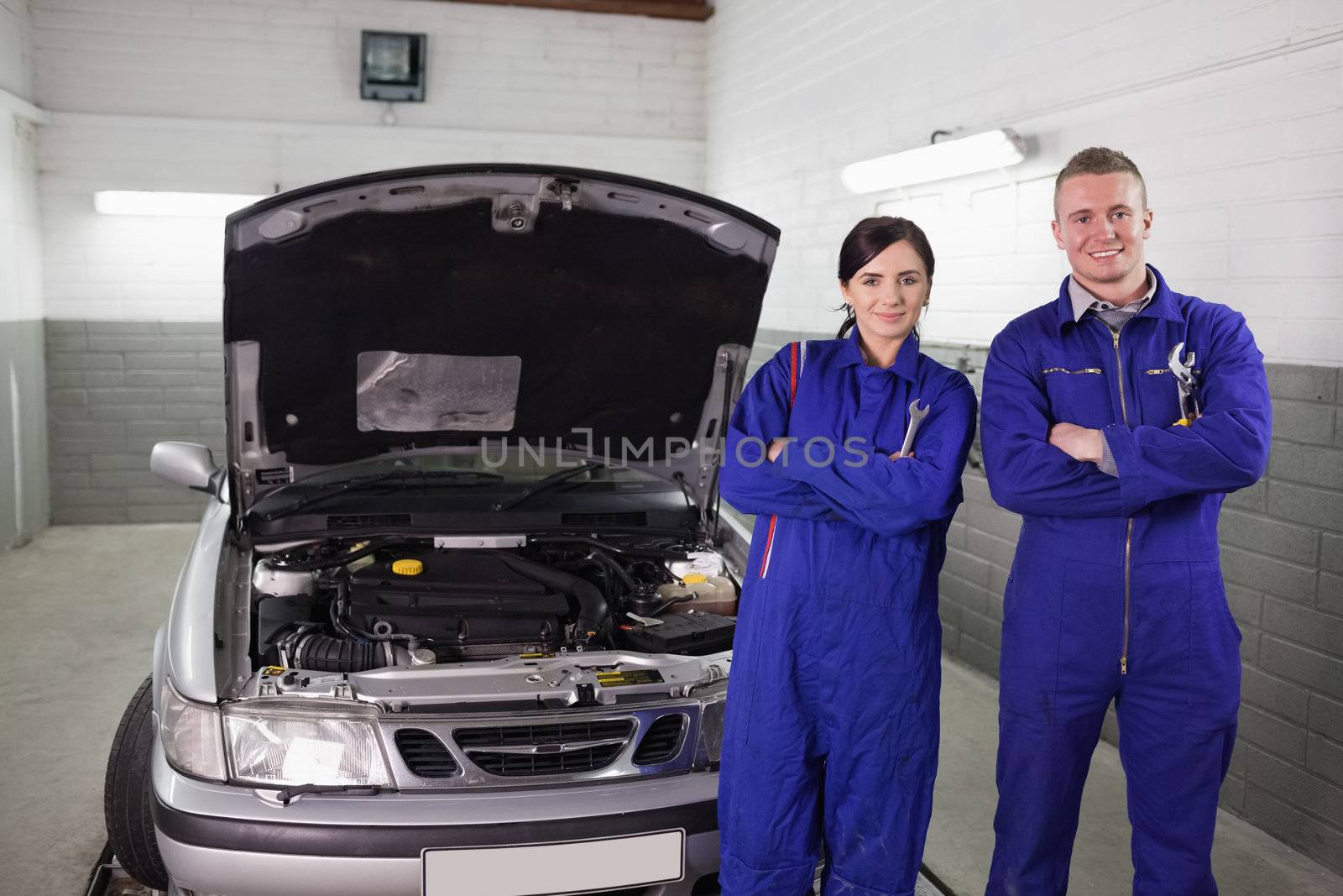 Mechanics next to a car a garage