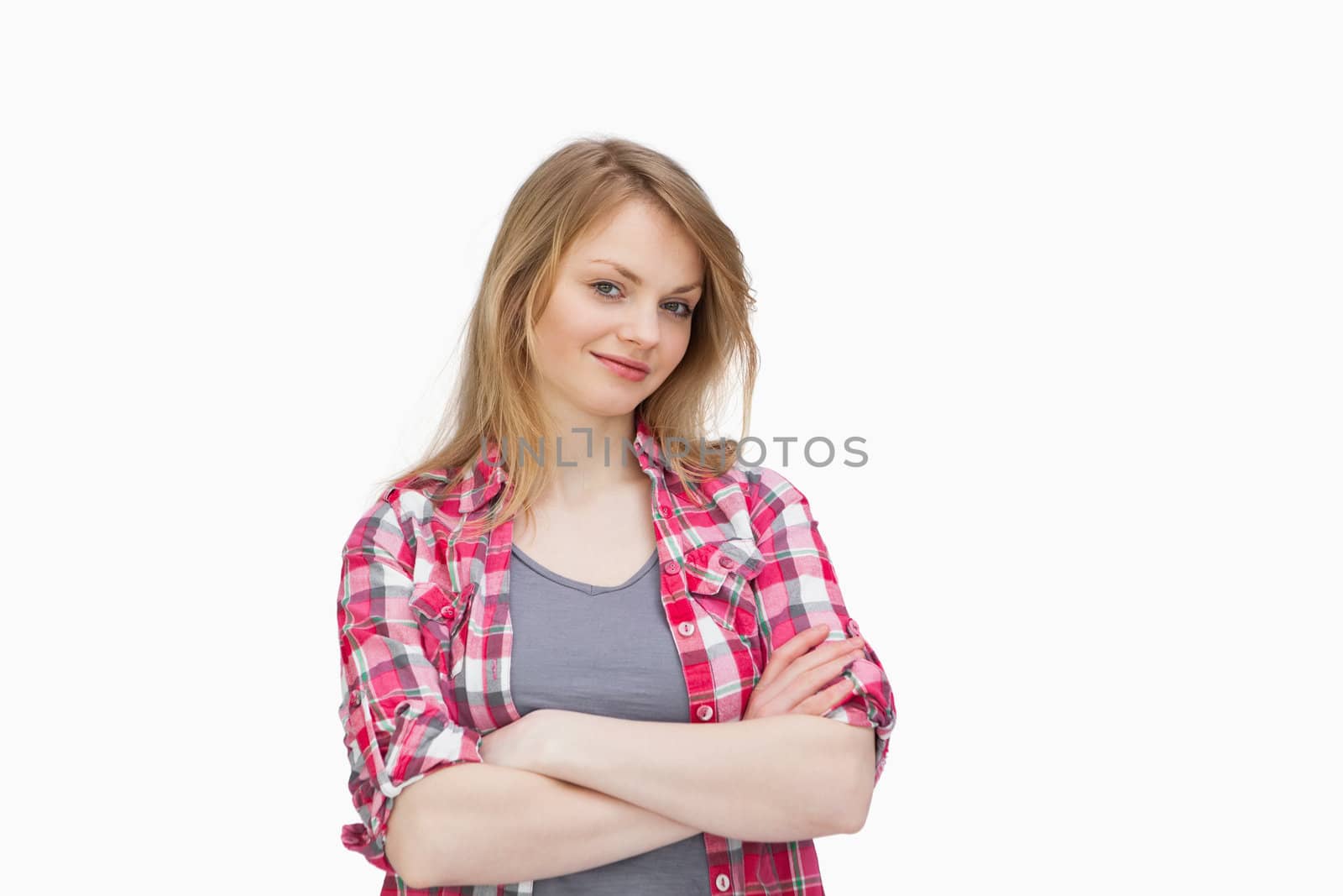 Front view of a woman smiling with arms crossed against a white background