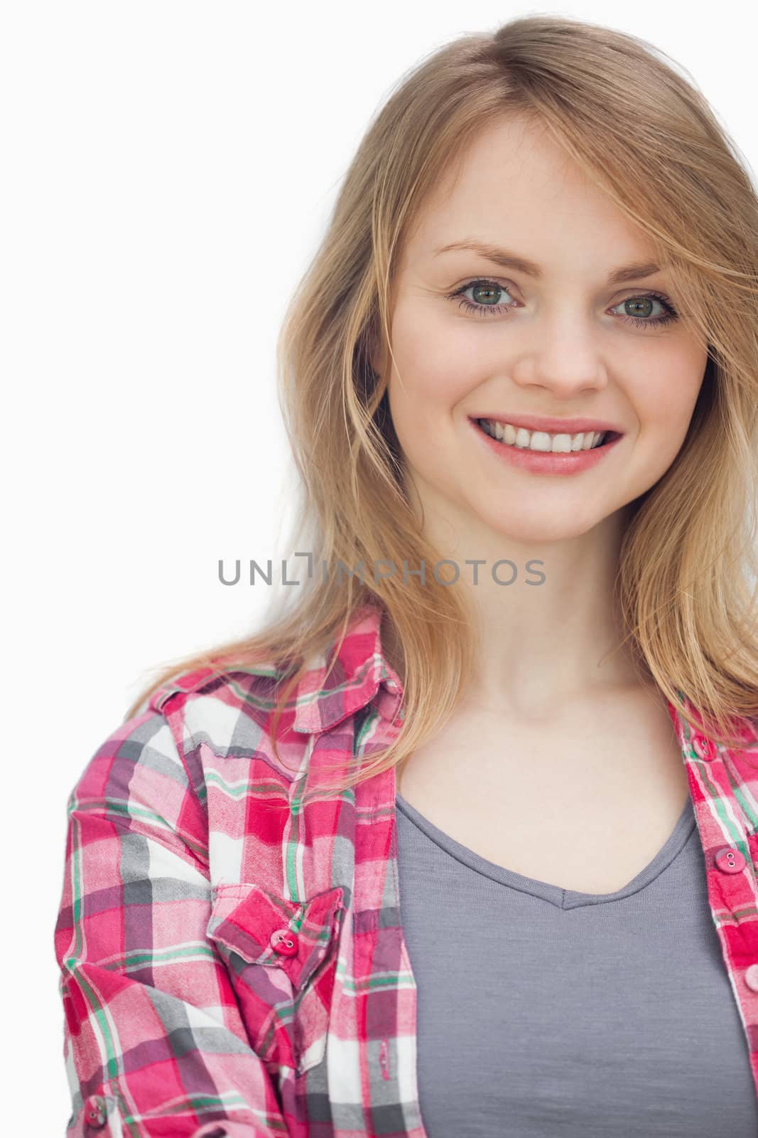 Blonde woman smiling against a white background