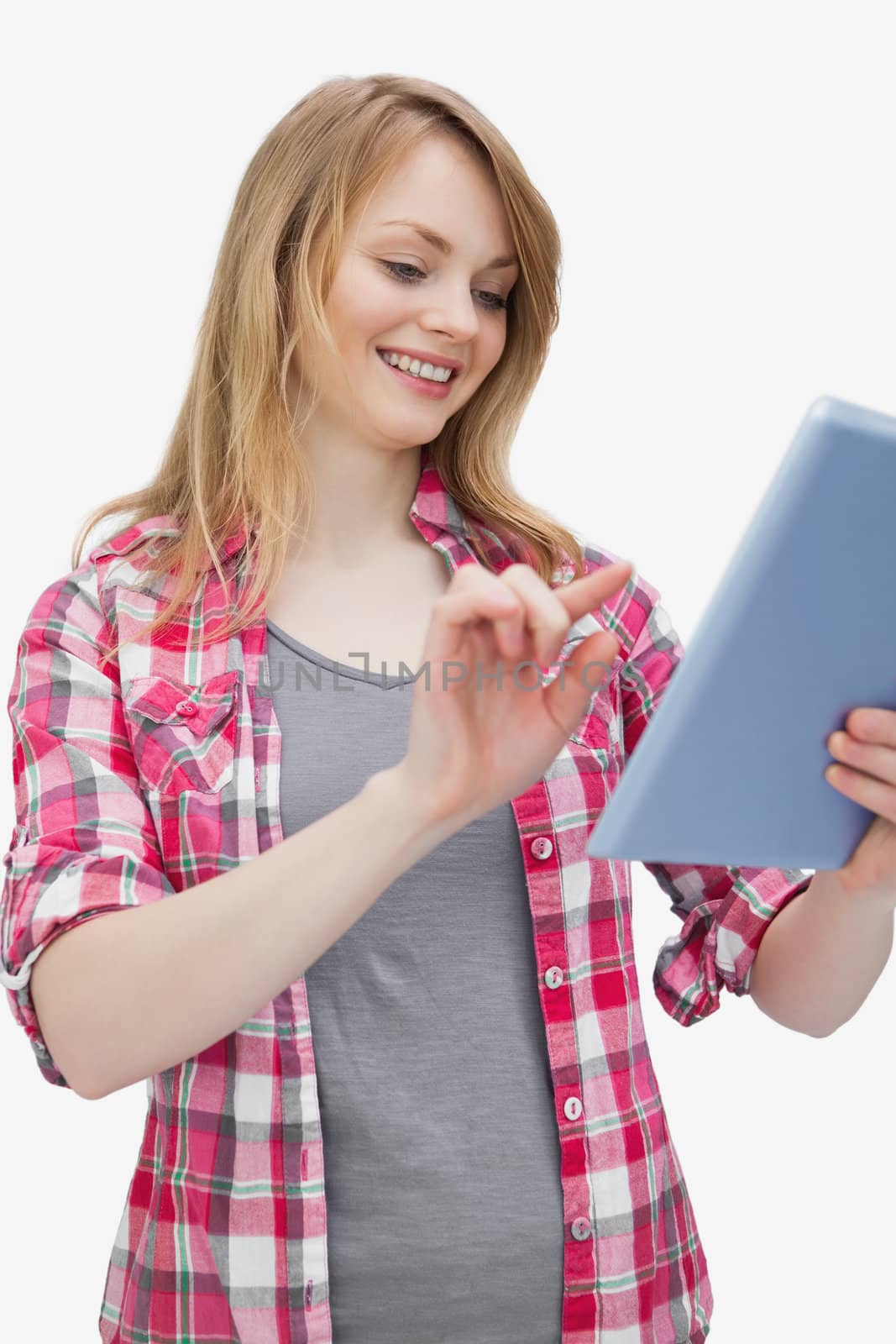 Woman touching a tablet computer while looking it against a white background