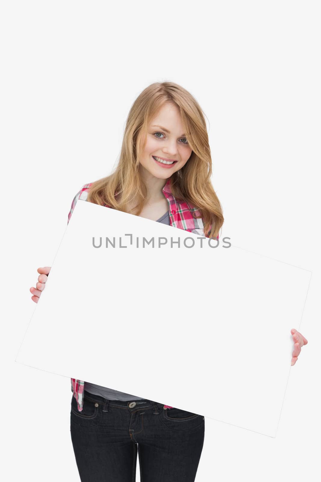 Smiling woman holding a blank board against a white background
