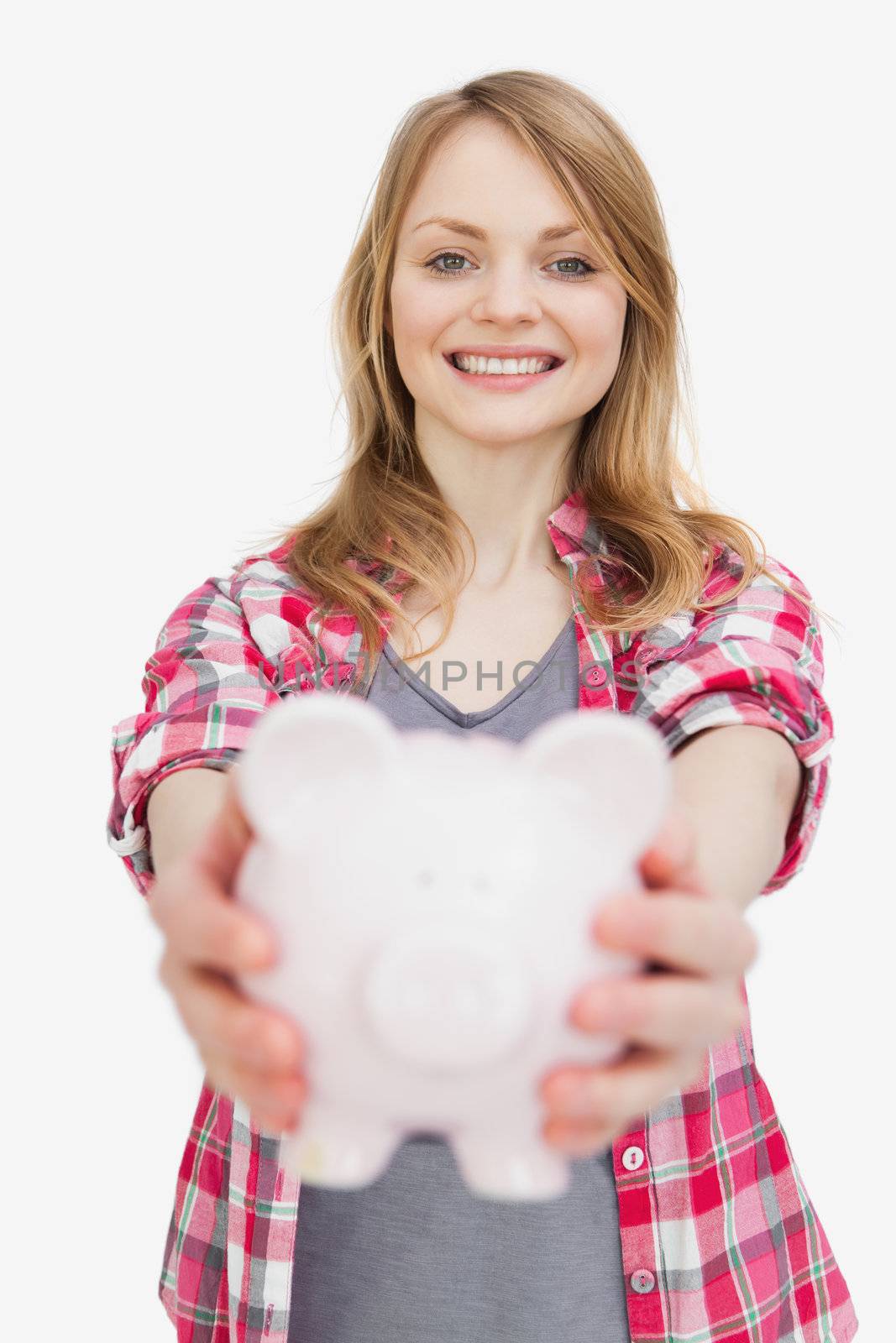 Focus of a woman holding a piggy bank against a white background
