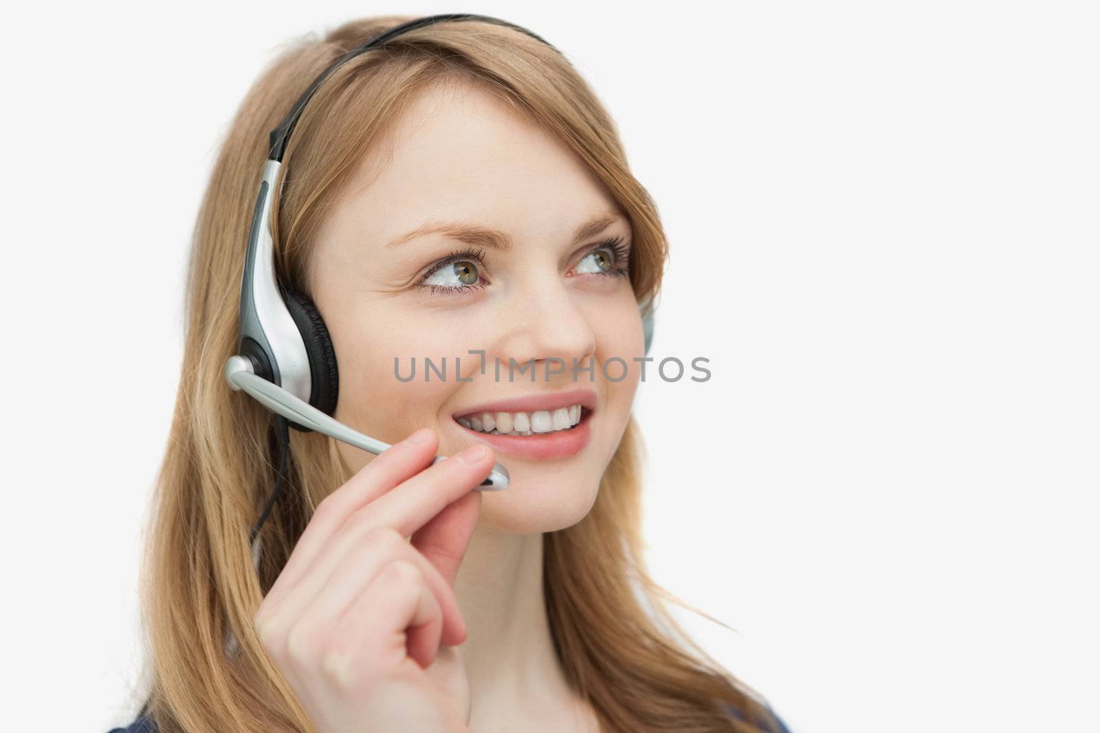Woman with headset looking up against a white background