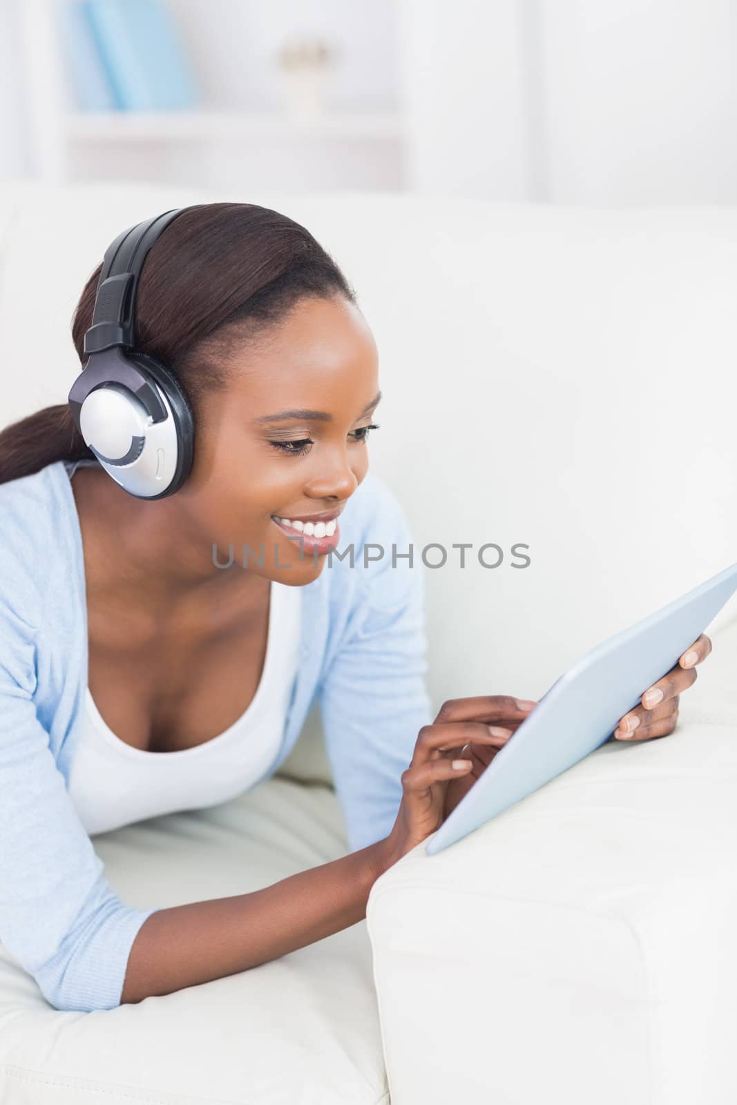 Black woman using a tablet computer in a living room