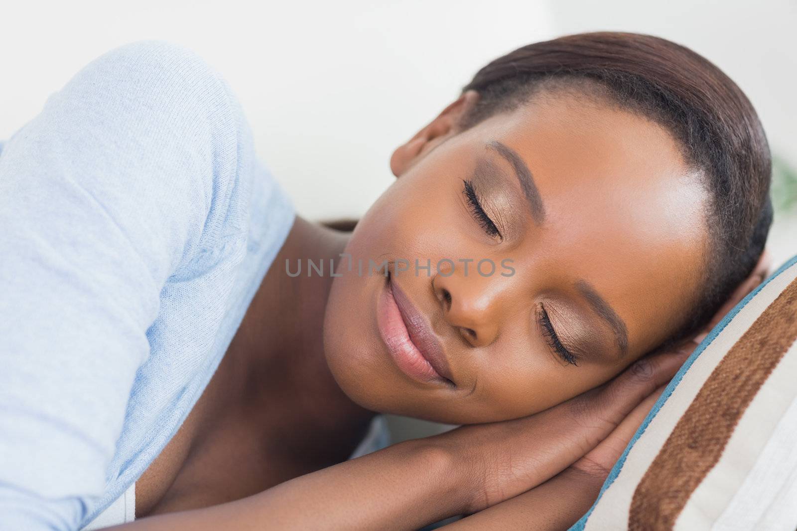 Black woman with closed eyes in a living room