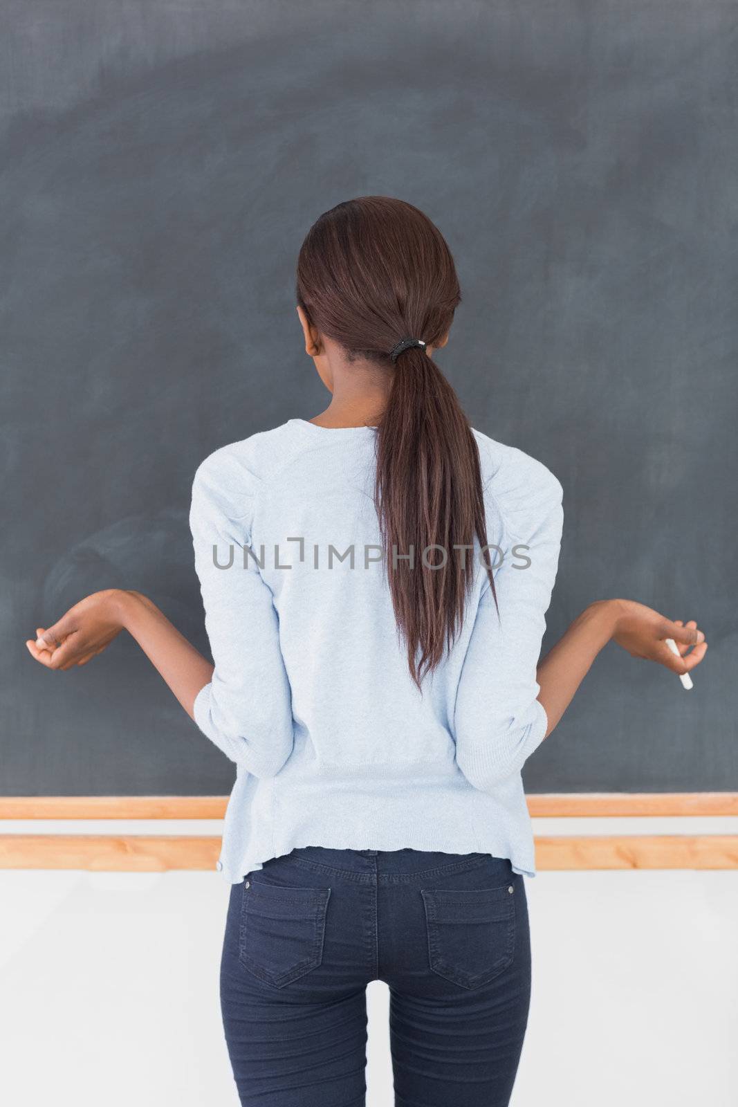 Black woman seeming uncertain in a classroom