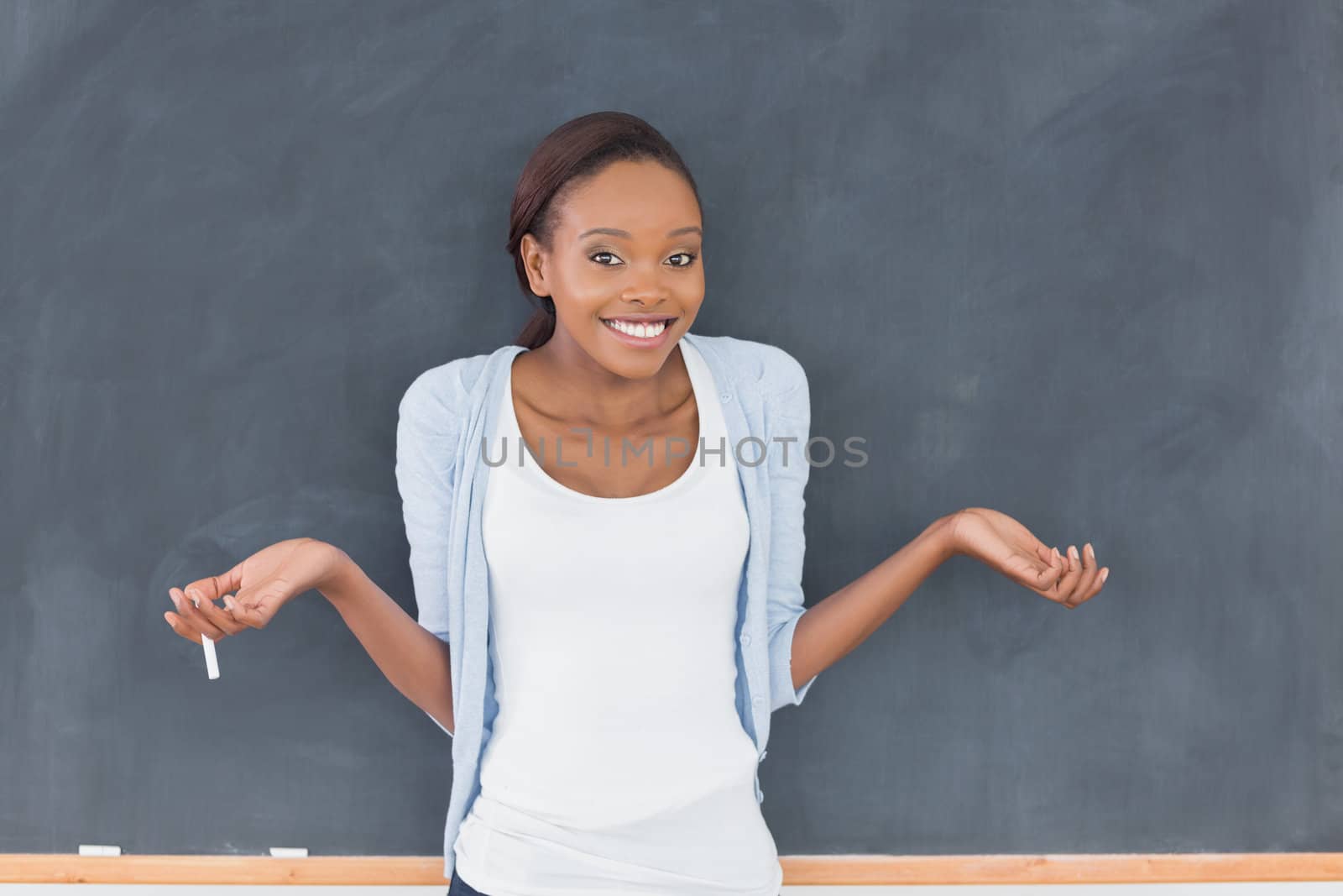Black woman hesitating while smiling in a classroom