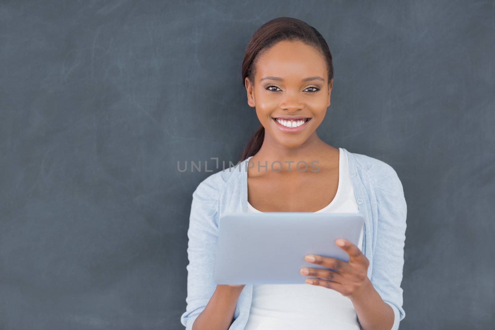 Front view of a black woman looking at camera in a classroom