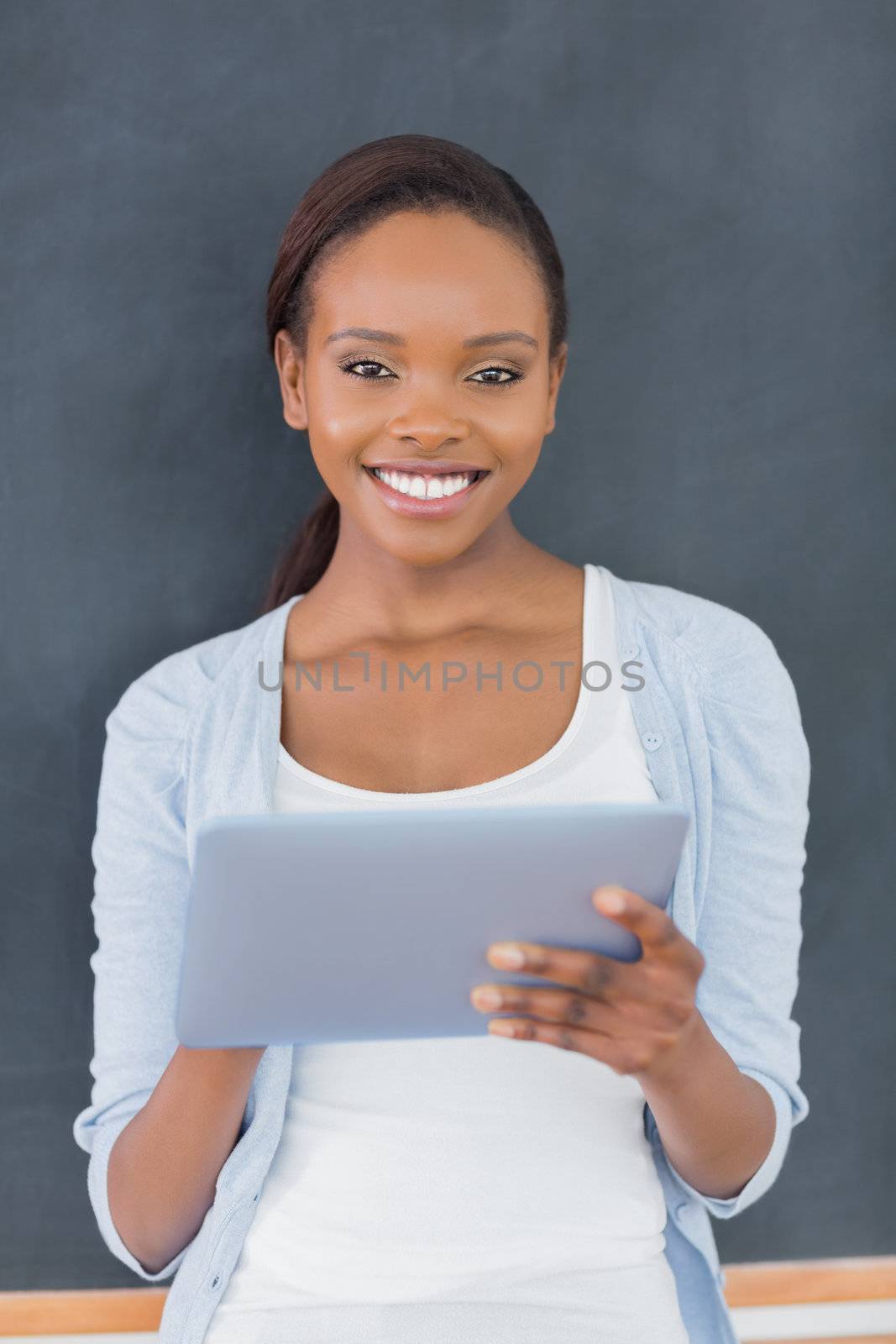 Front view of a black woman standing in a classroom