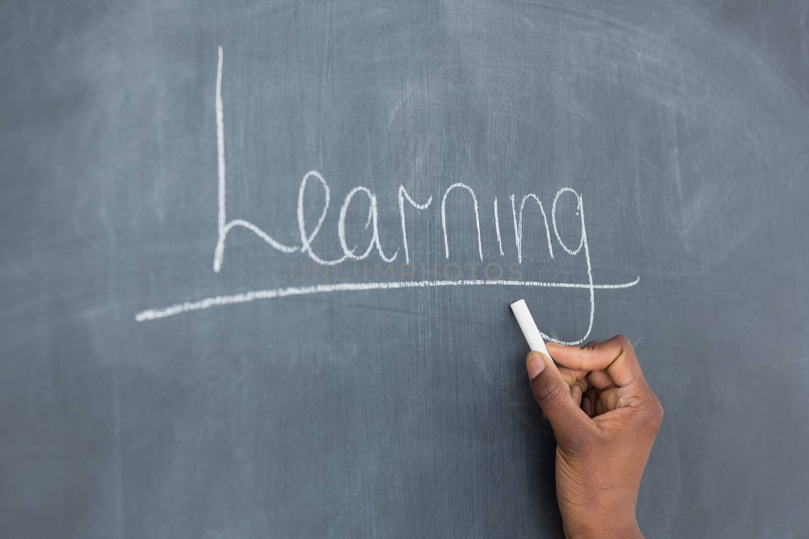 Someone showing the blackboard in a classroom