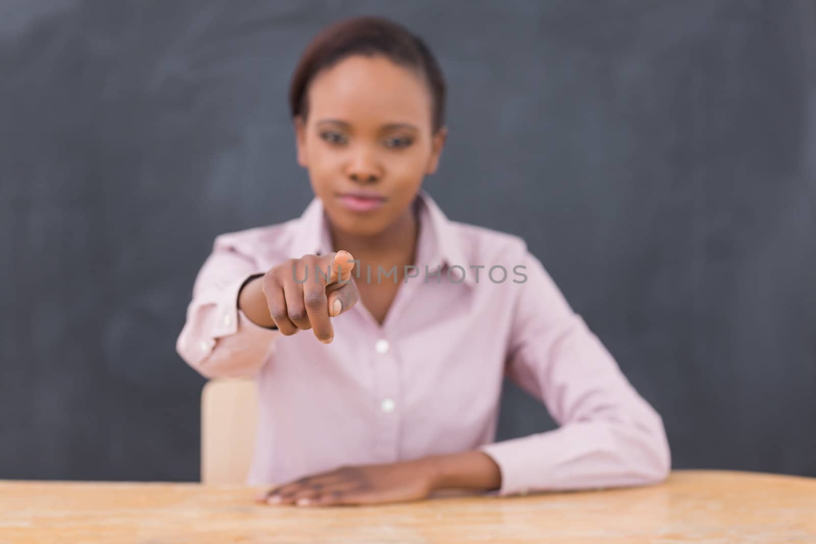 Strict teacher pointing of  finger in a classroom
