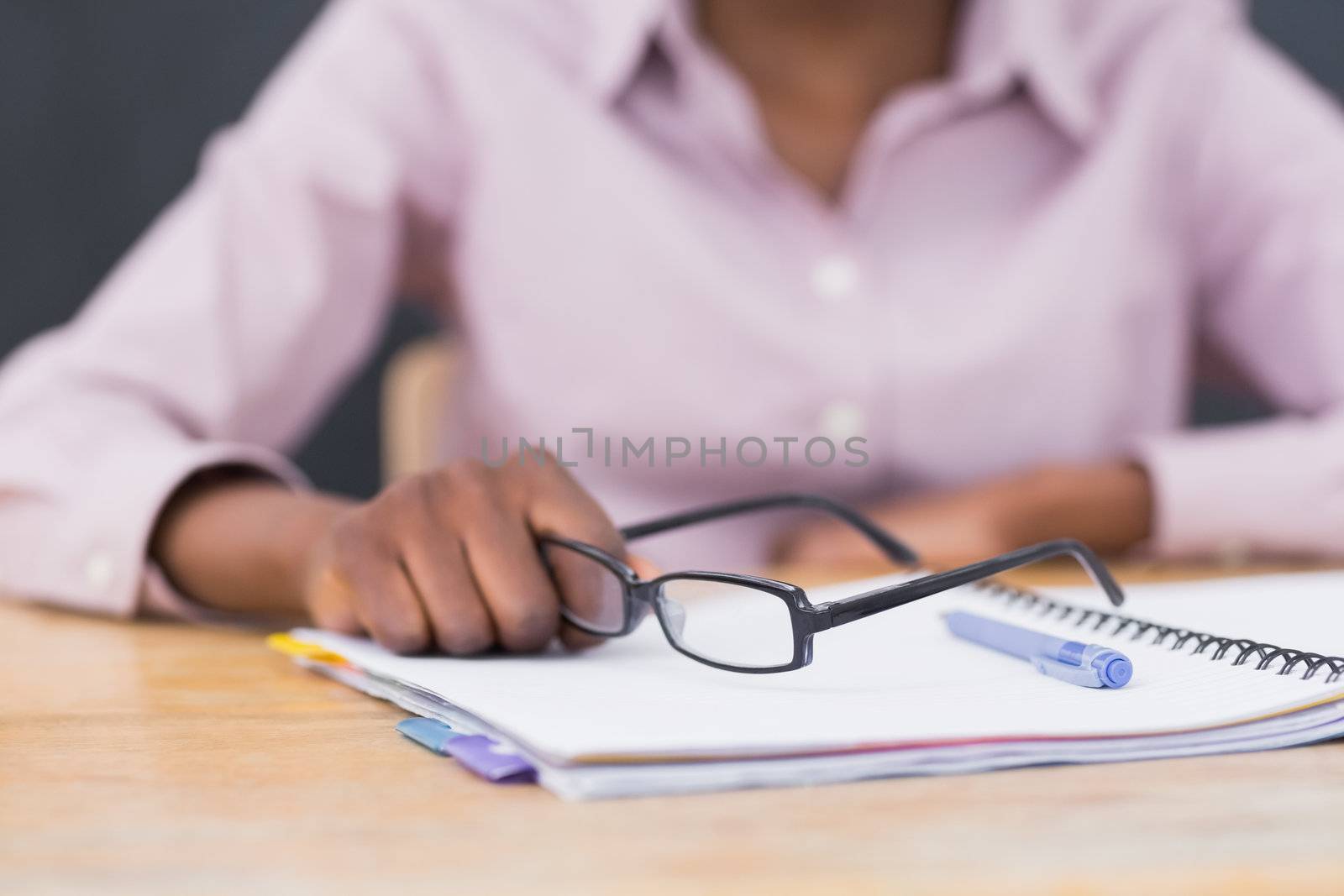Close up of a notebook and glasses in a classroom