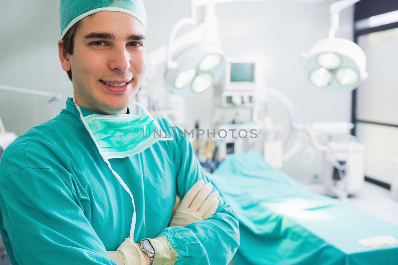 Male surgeon looking at camera in an operating theatre