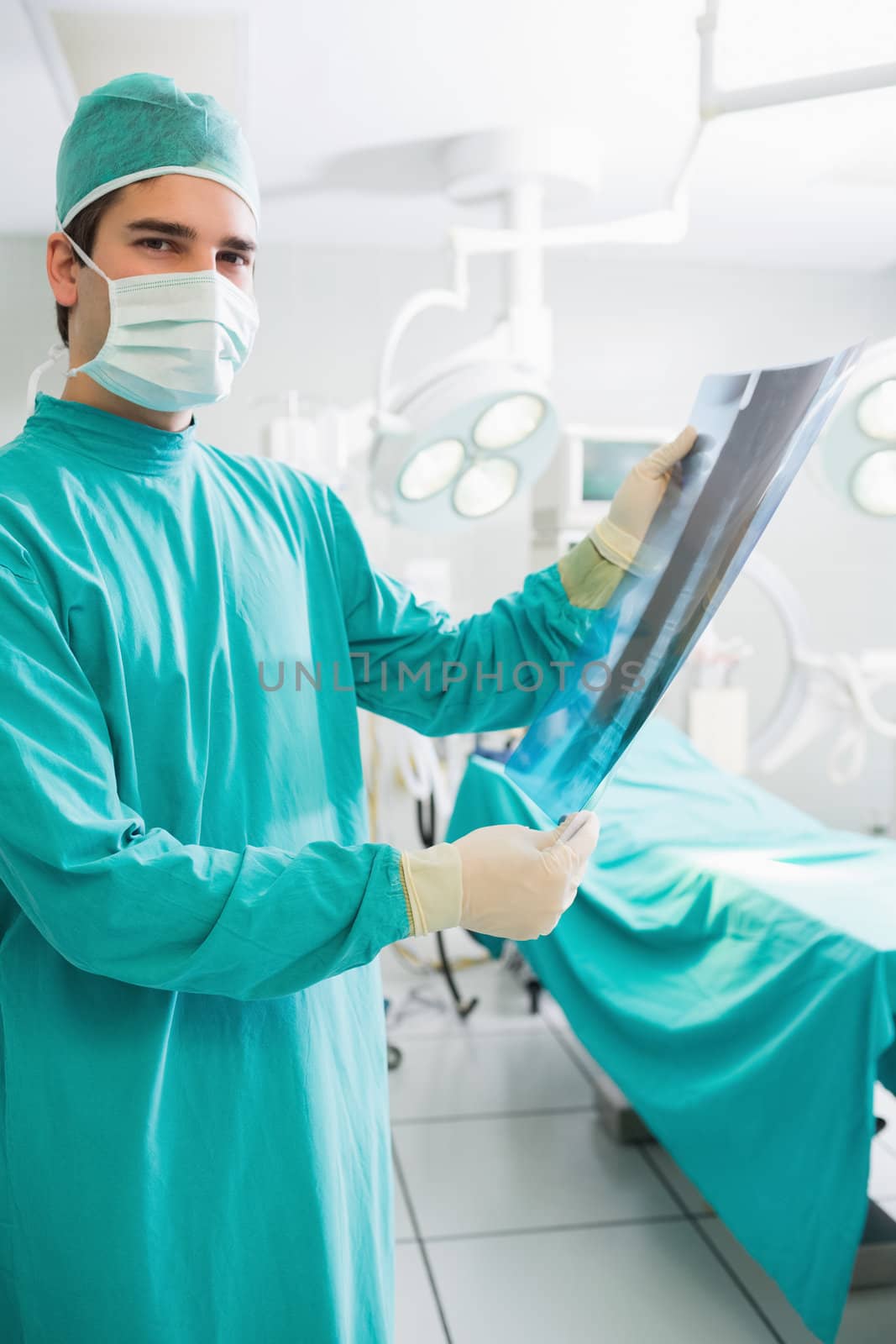 Surgeon holding a X-ray in an operating theatre