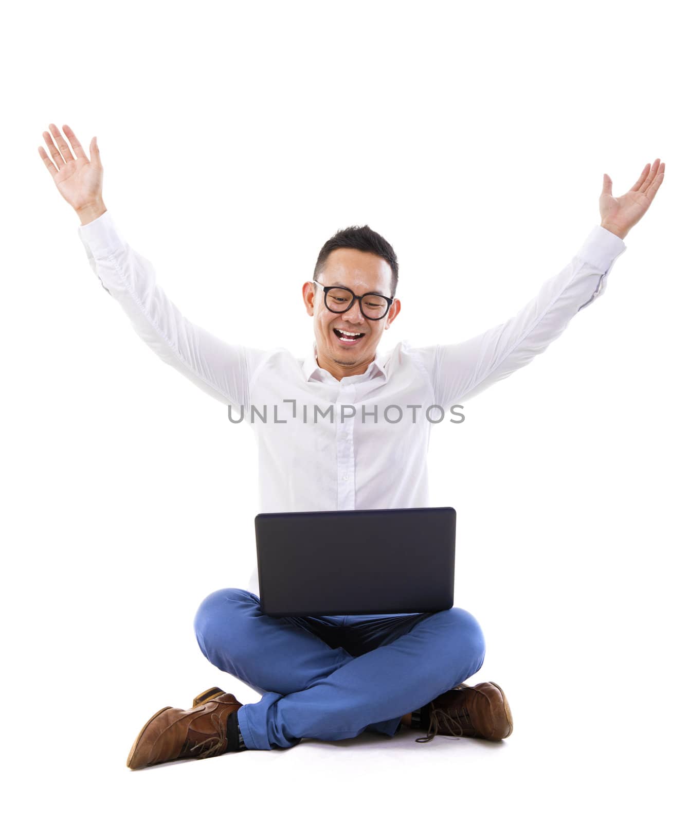 Full length of Asian businessman with hands raise looking at laptop over white background