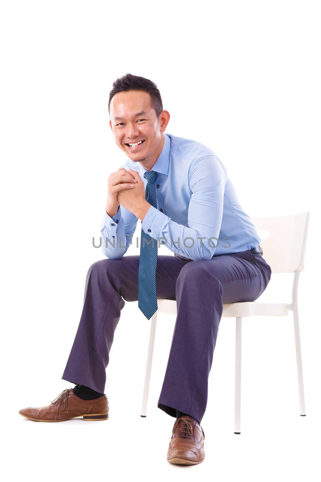 Full body Asian business man sitting on a chair over white background