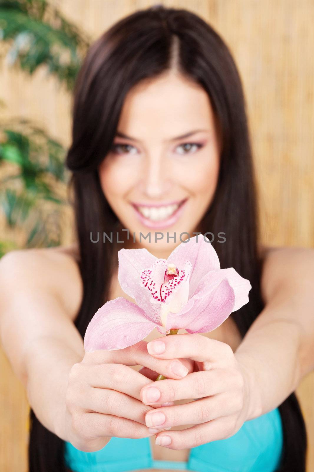 happy woman holding orchid, focus on flower by imarin