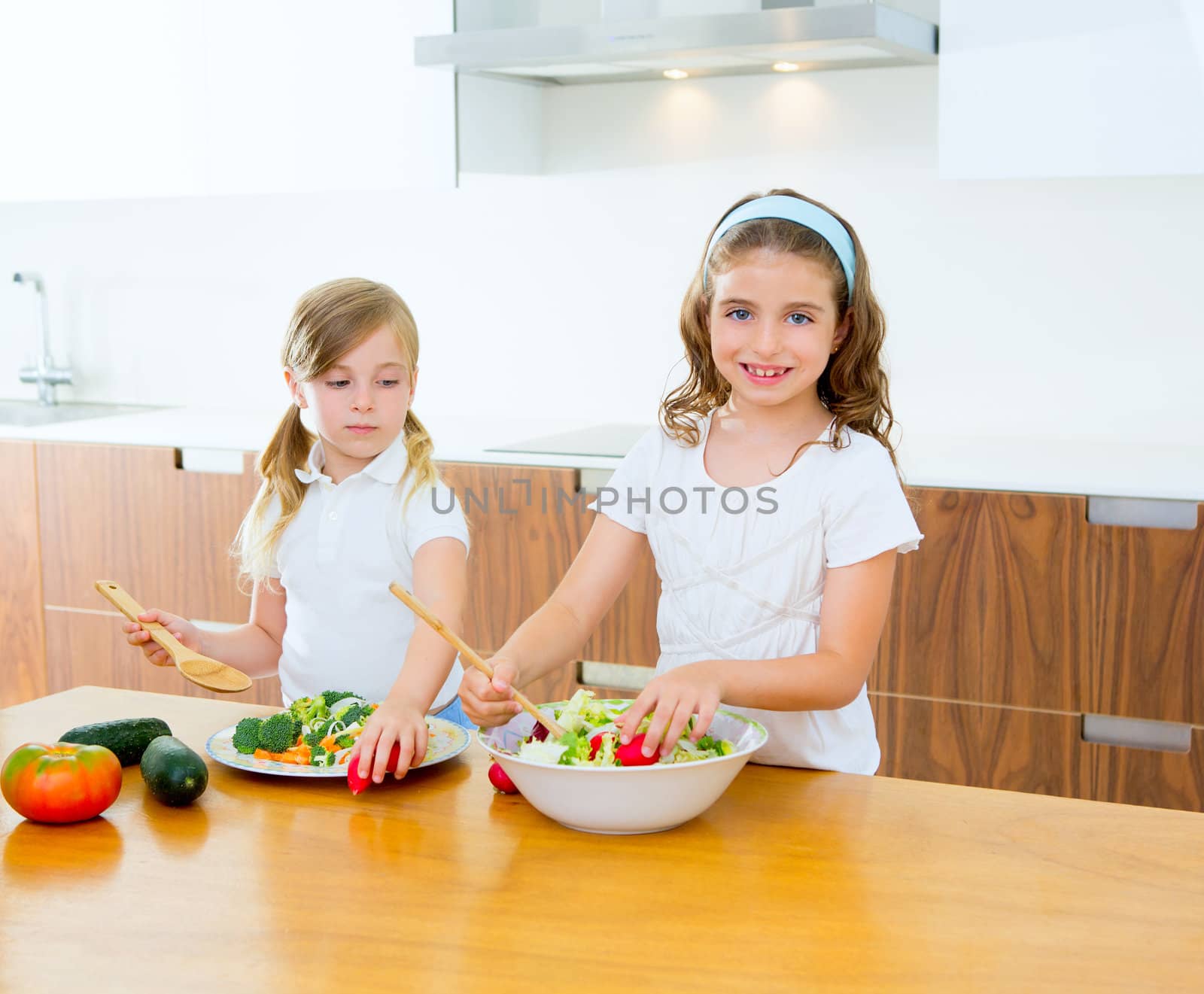 Beautiful chef sisters at home kitchen preparing salad