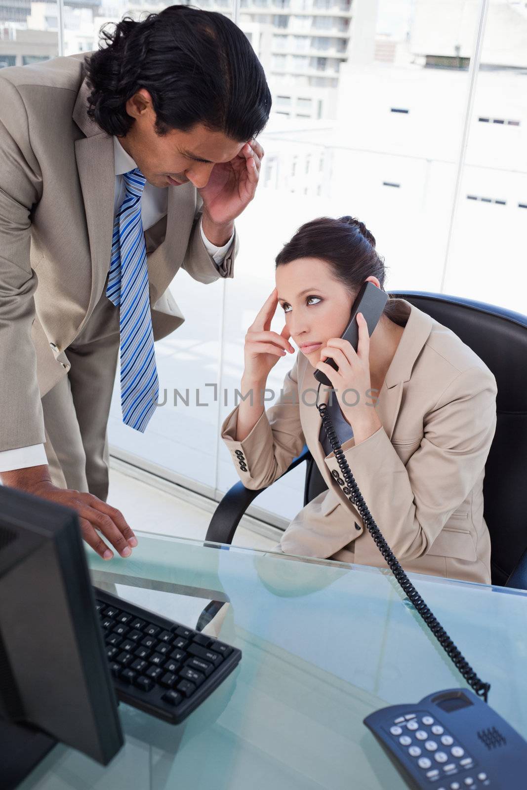 Portrait of a tired business team on the phone in an office