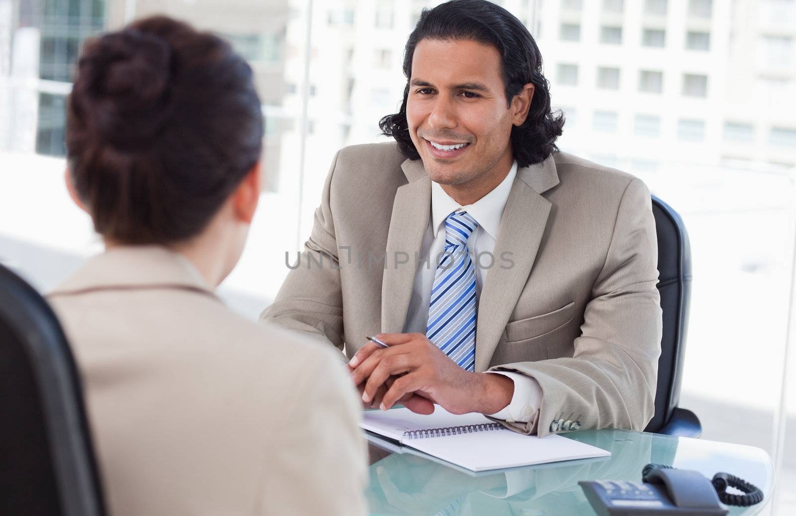 Manager interviewing a female applicant in his office