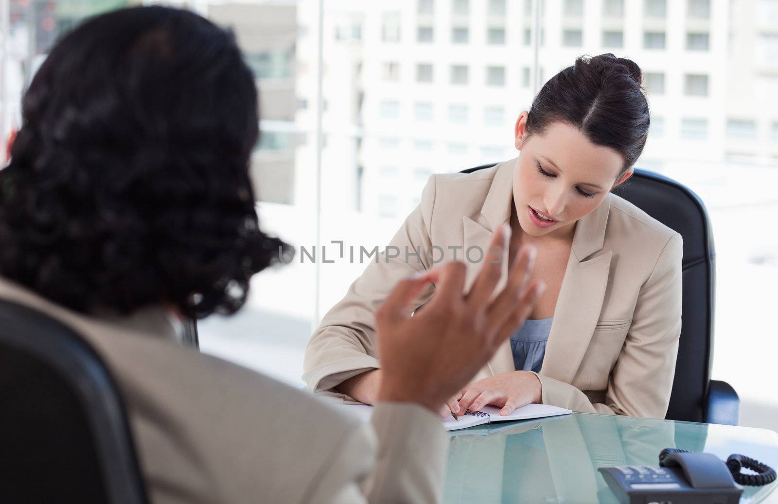 Manager interviewing a male applicant in her office