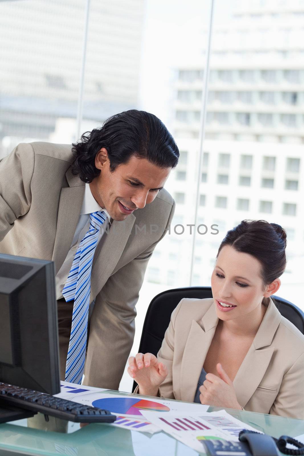 Portrait of a smiling business team making a market research in an office
