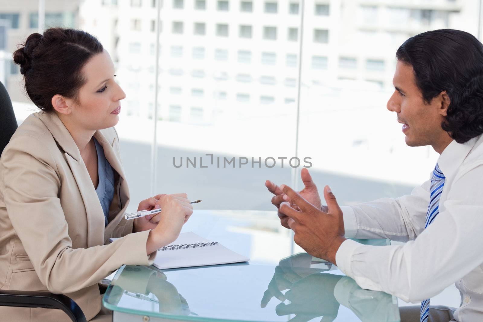 Young business people negotiating in a meeting room