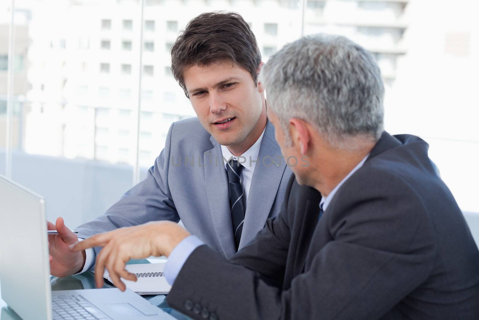Businessmen working with a laptop in an office