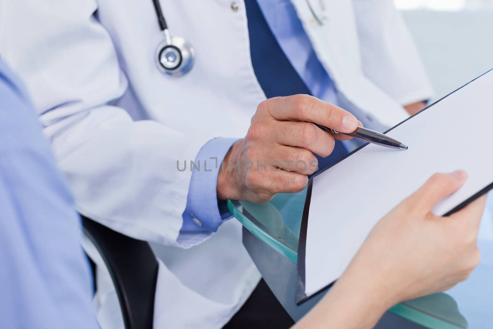 Close up of a medical team looking a document in an office