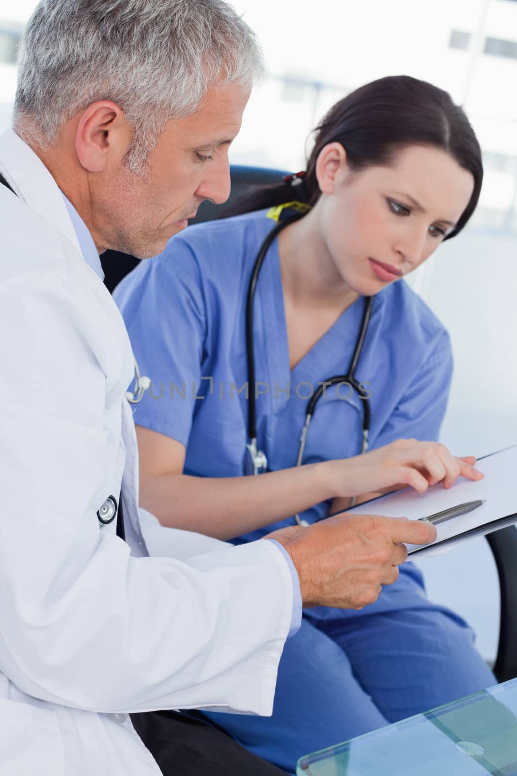 Portrait of a medical team looking a document in an office