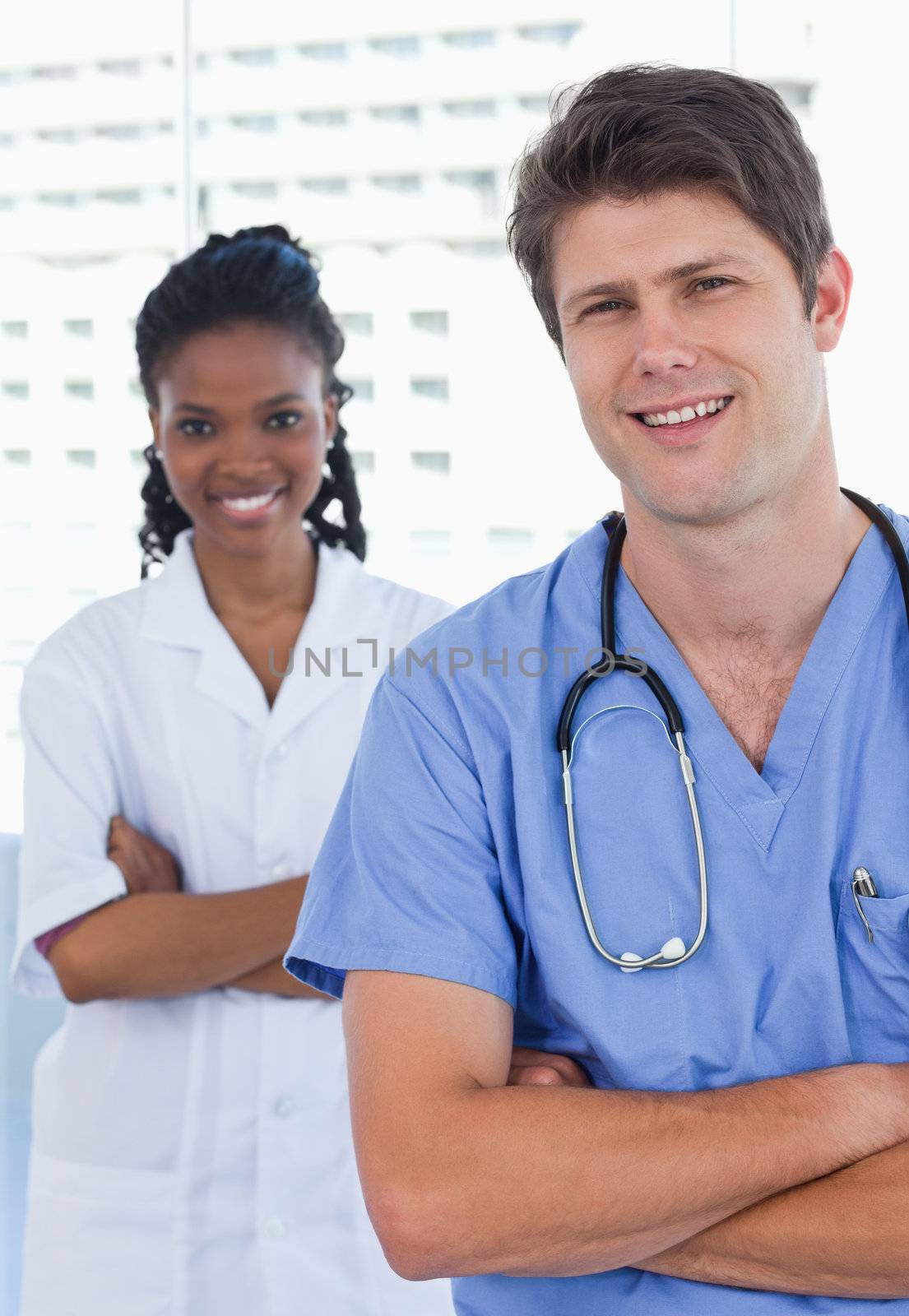 Portrait of happy doctors standing up in an office