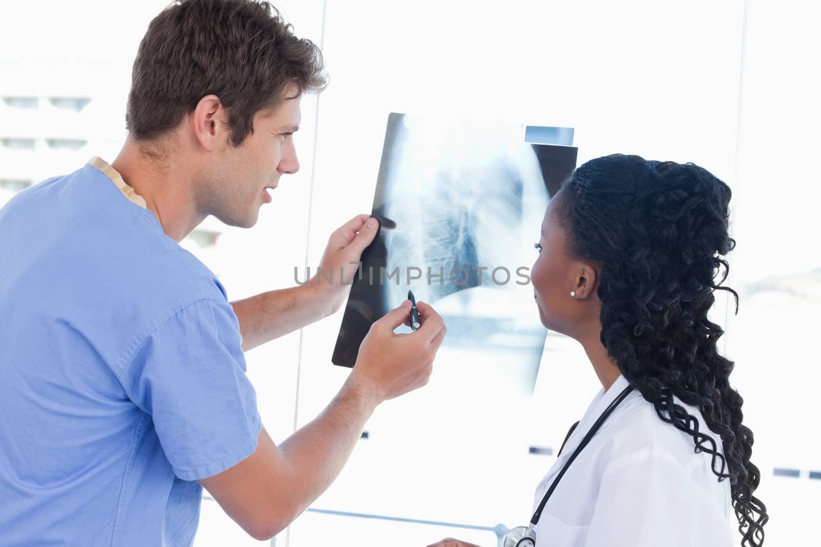 Happy doctors looking at a of X-ray in an office