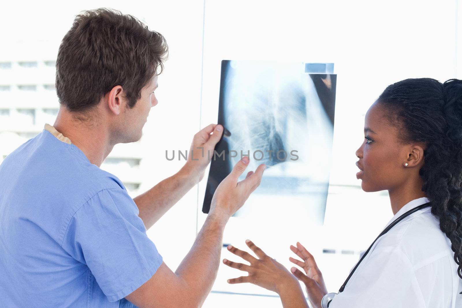 Young doctors looking at a of X-ray in an office