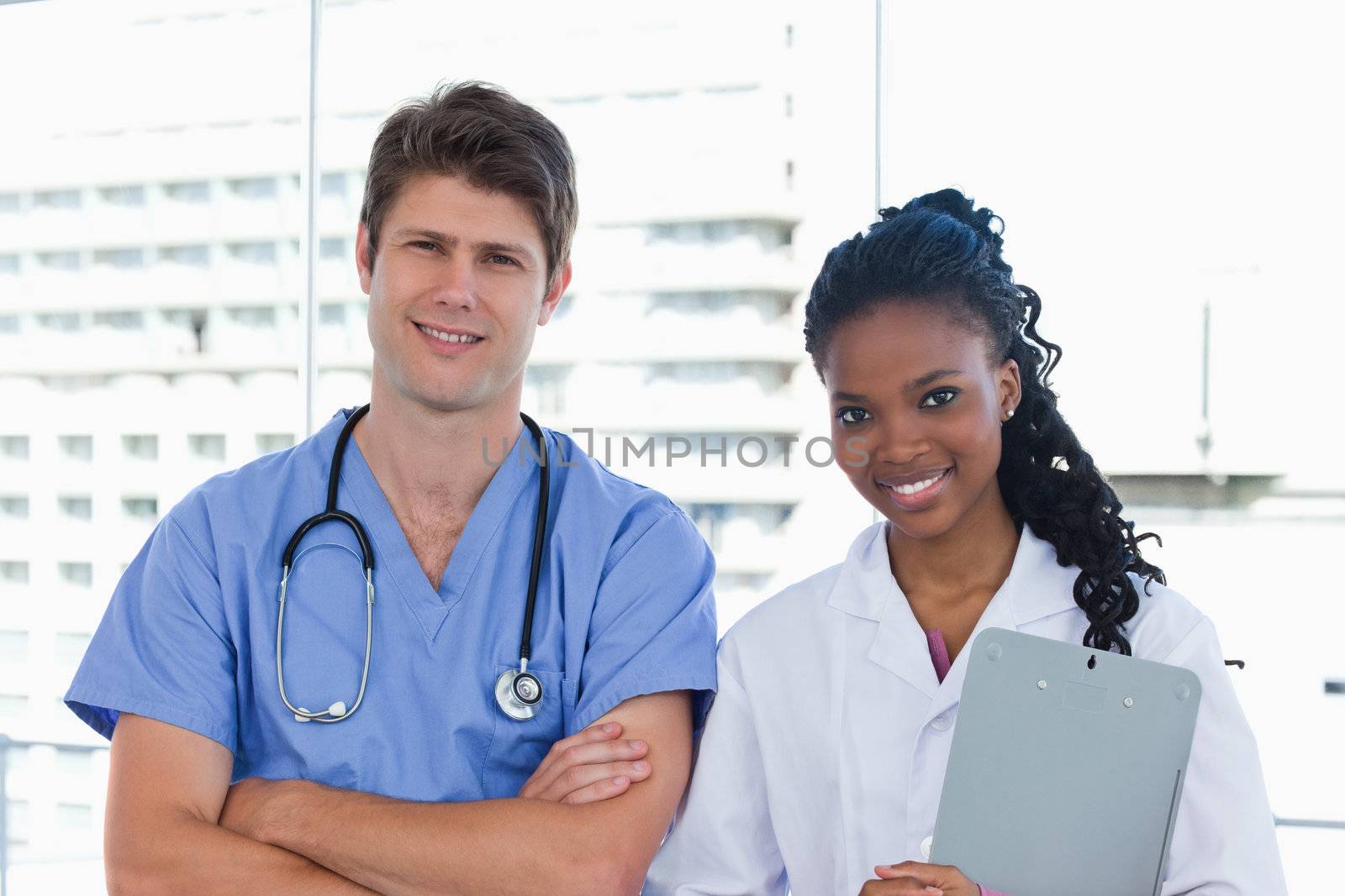 Happy doctors posing in an office