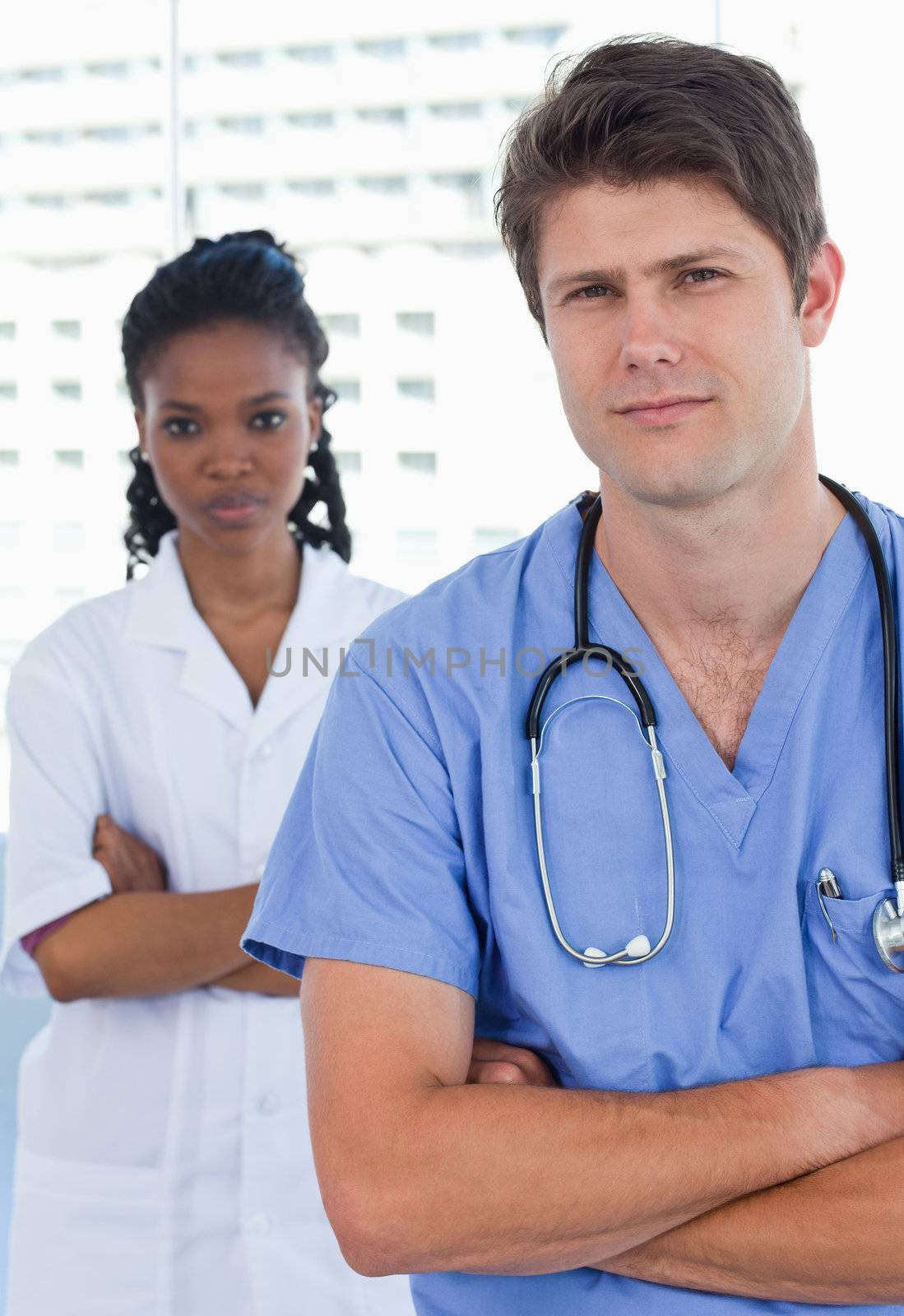 Portrait of professional doctors standing up in an office