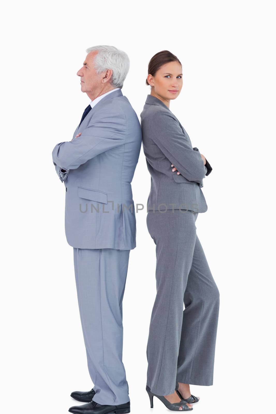 Mature businessman back to back with colleague against a white background