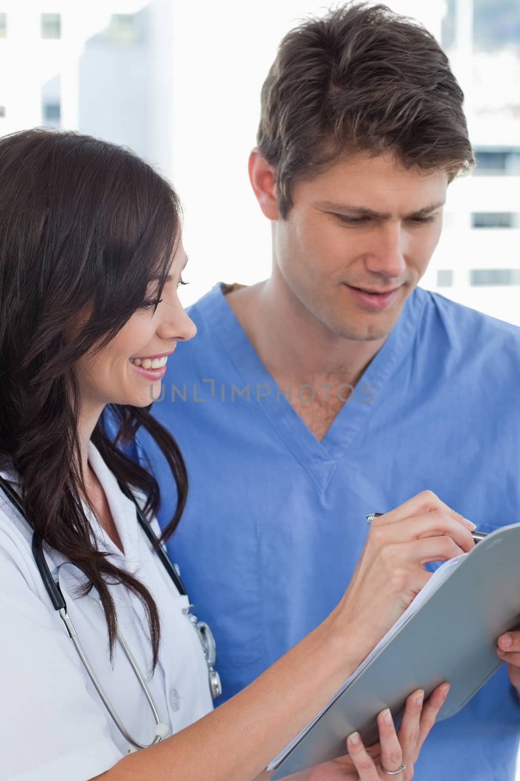 Portrait of smiling doctors looking at a document in an office