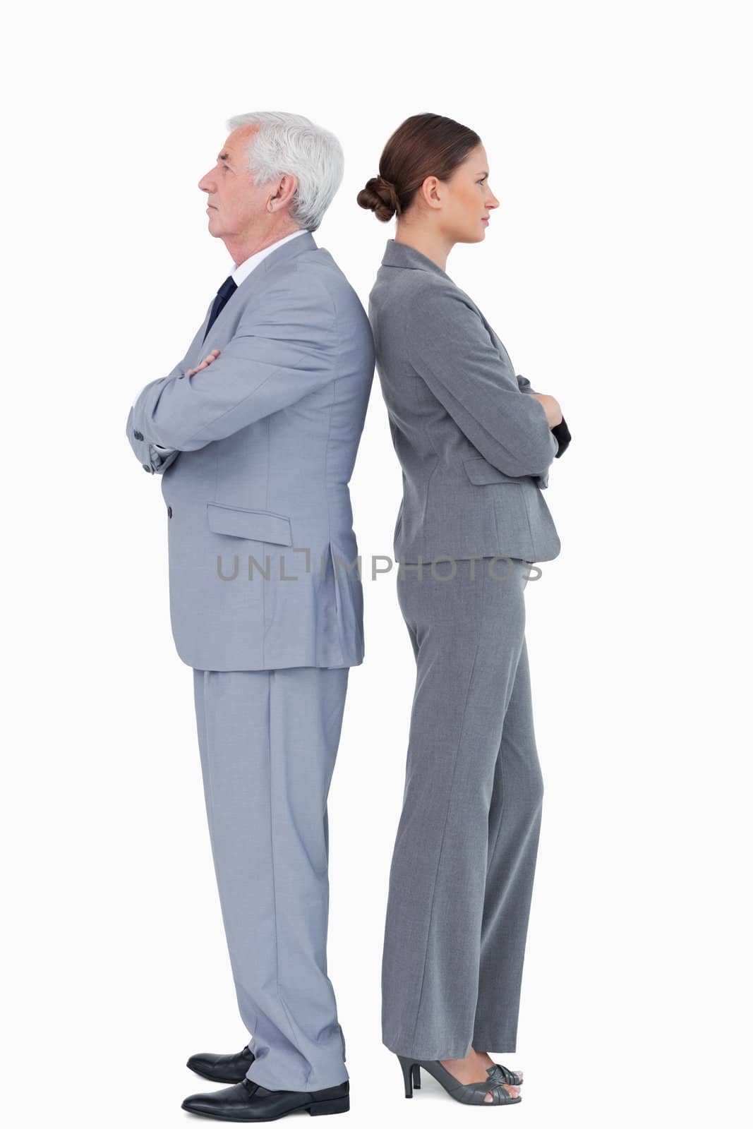 Businesspartner standing back to back against a white background