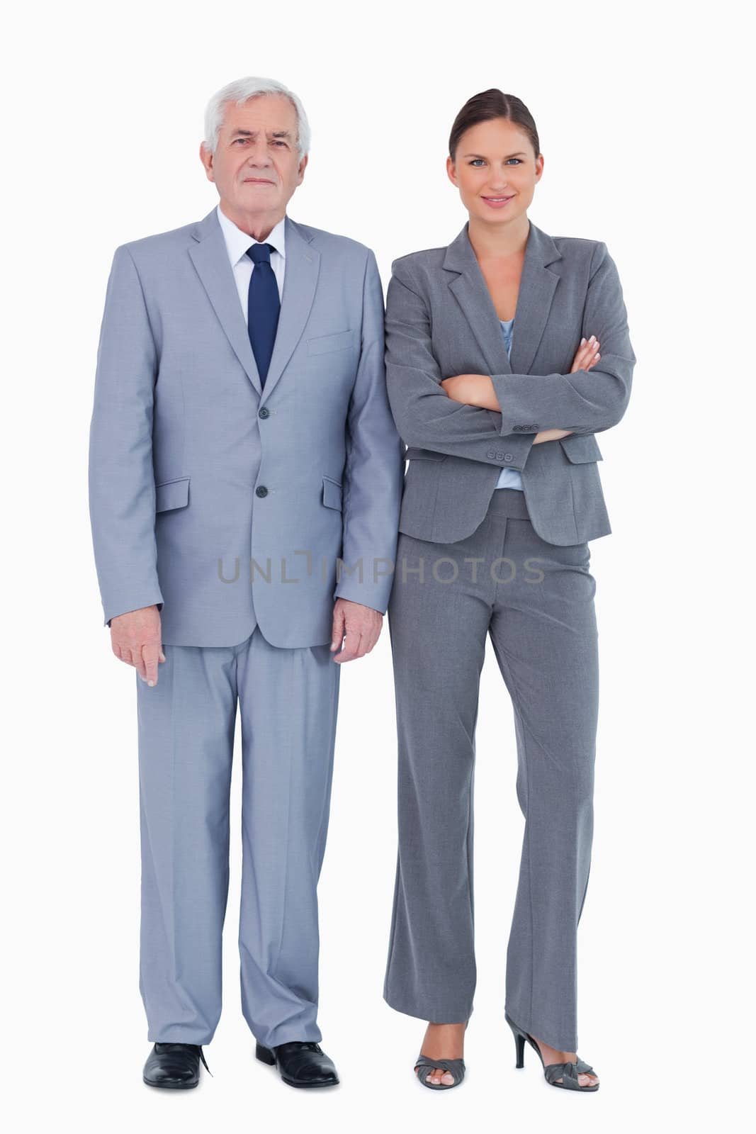 Mature businessman next to colleague against a white background