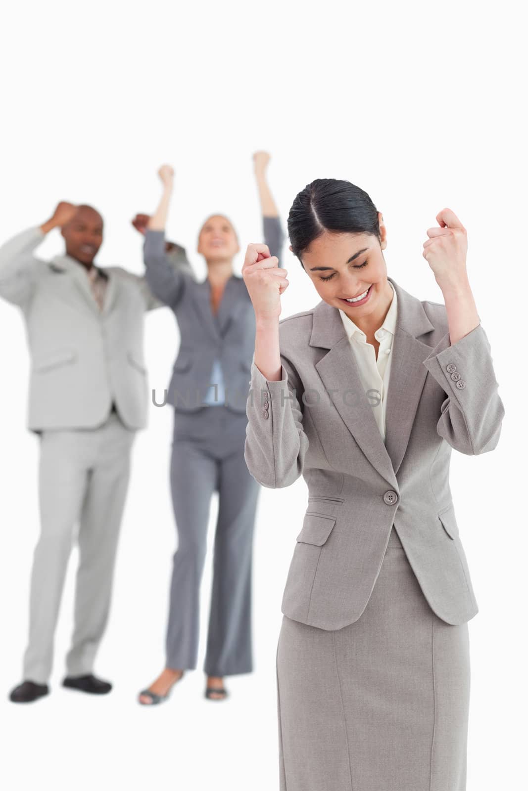 Successful businesswoman with cheering associates behind her against a white background