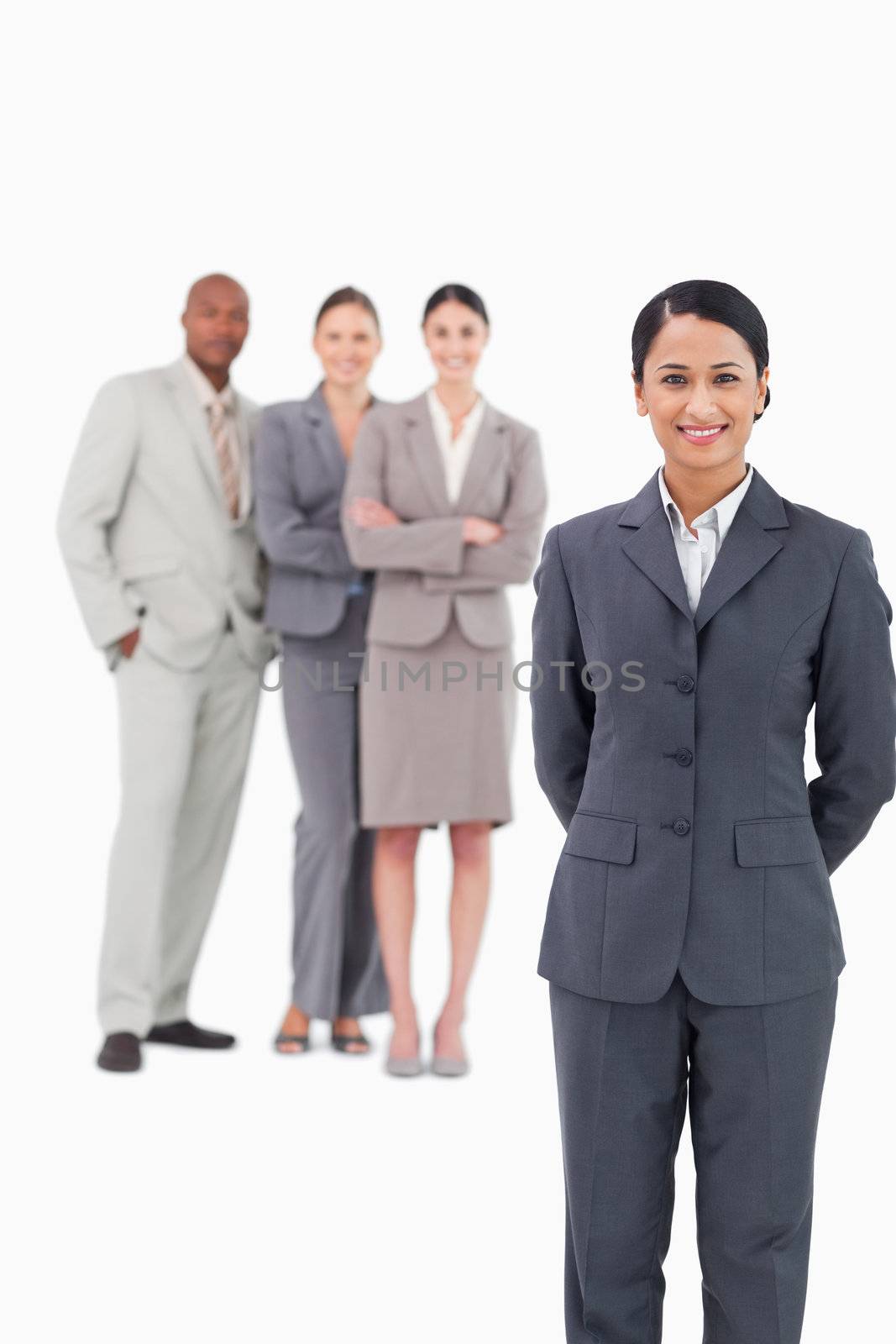 Saleswoman with her team behind her against a white background