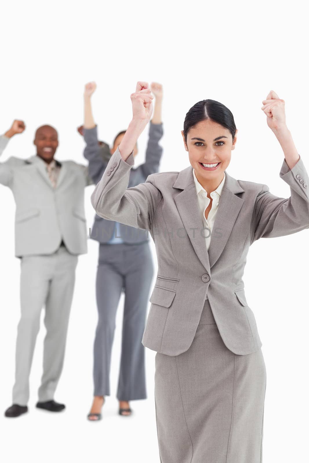 Triumphant saleswoman with cheering associates behind her against a white background
